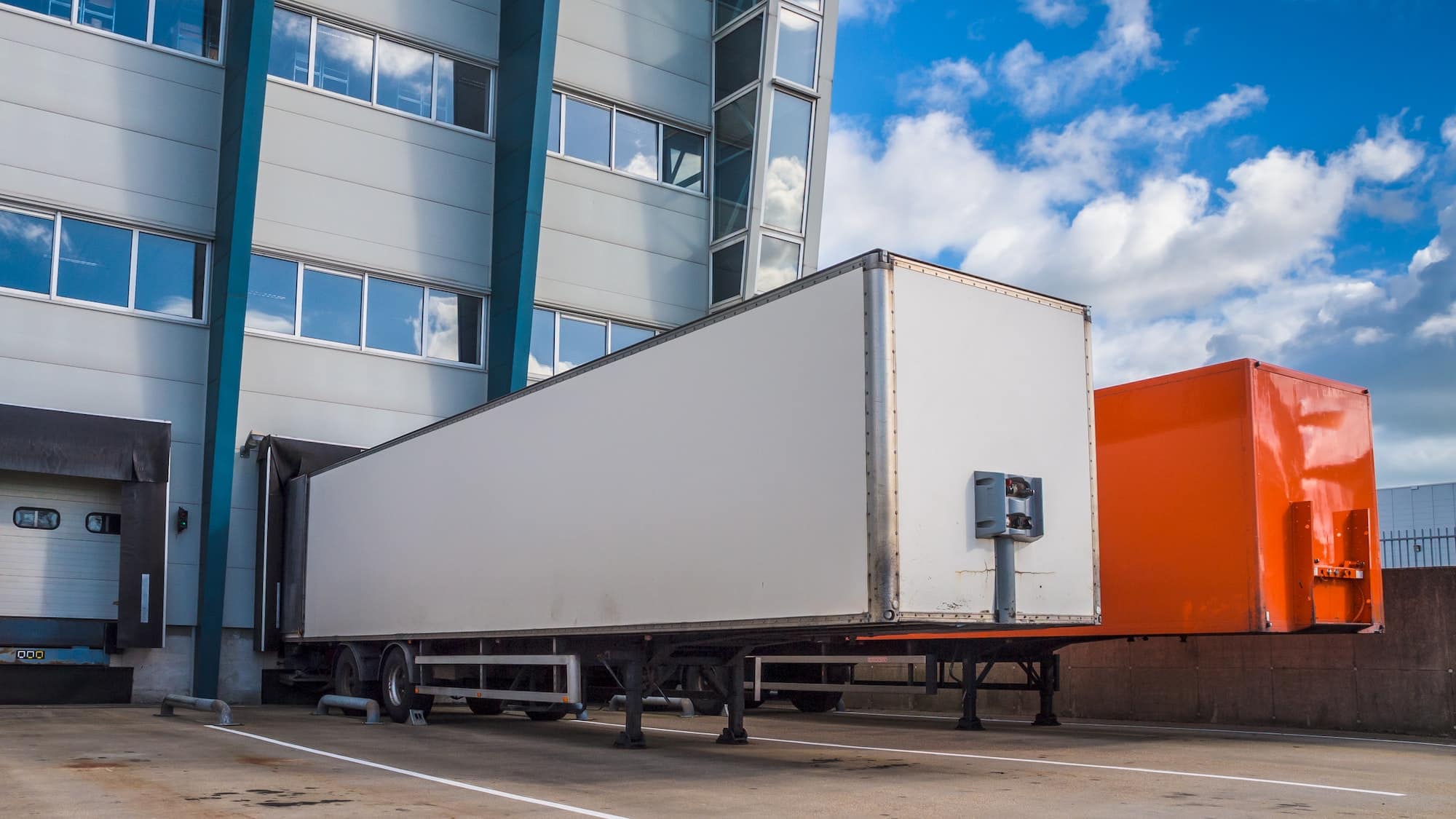 Large trailers backed up to a loading dock at a logistics center