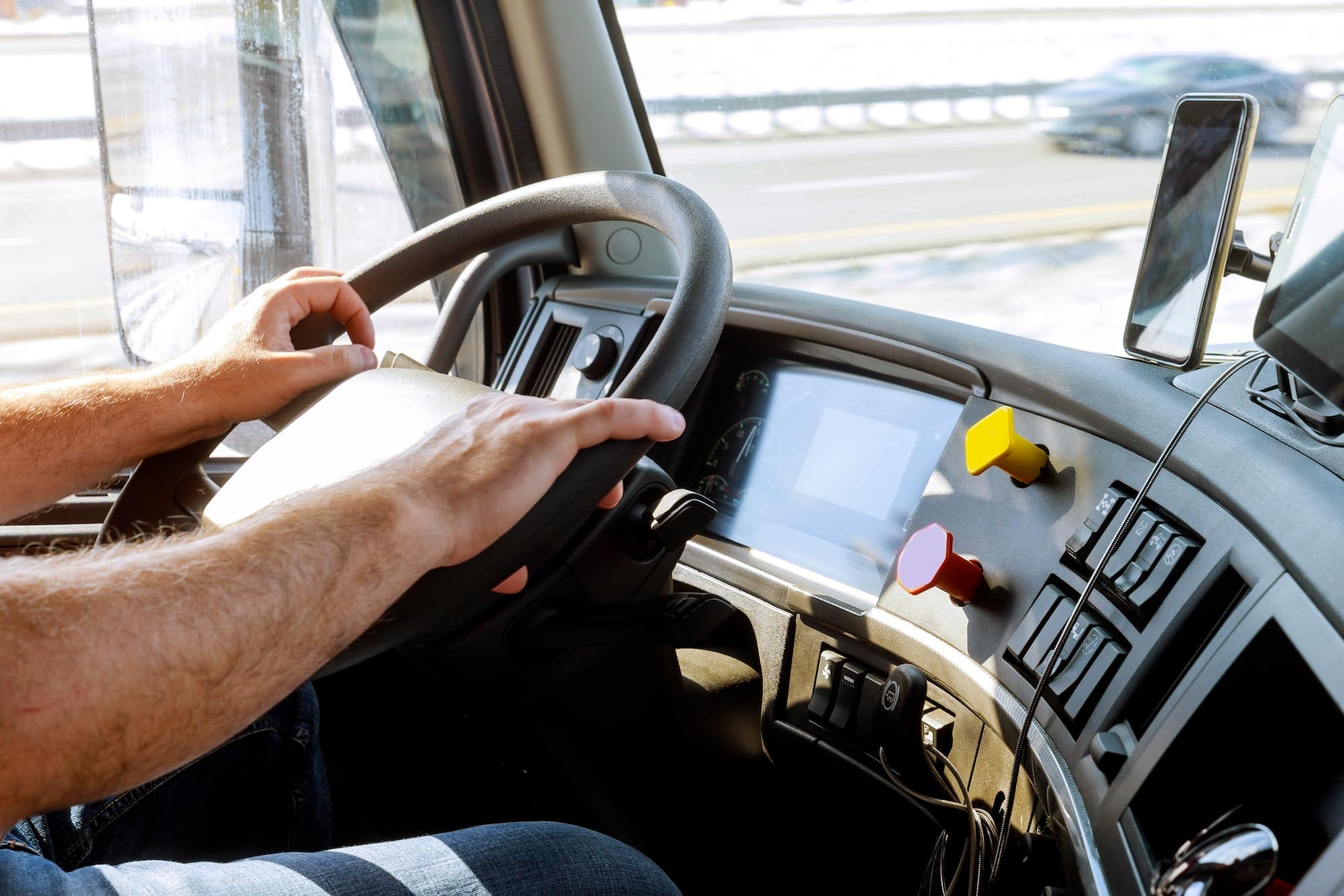 Truck driver's hands on steering wheel