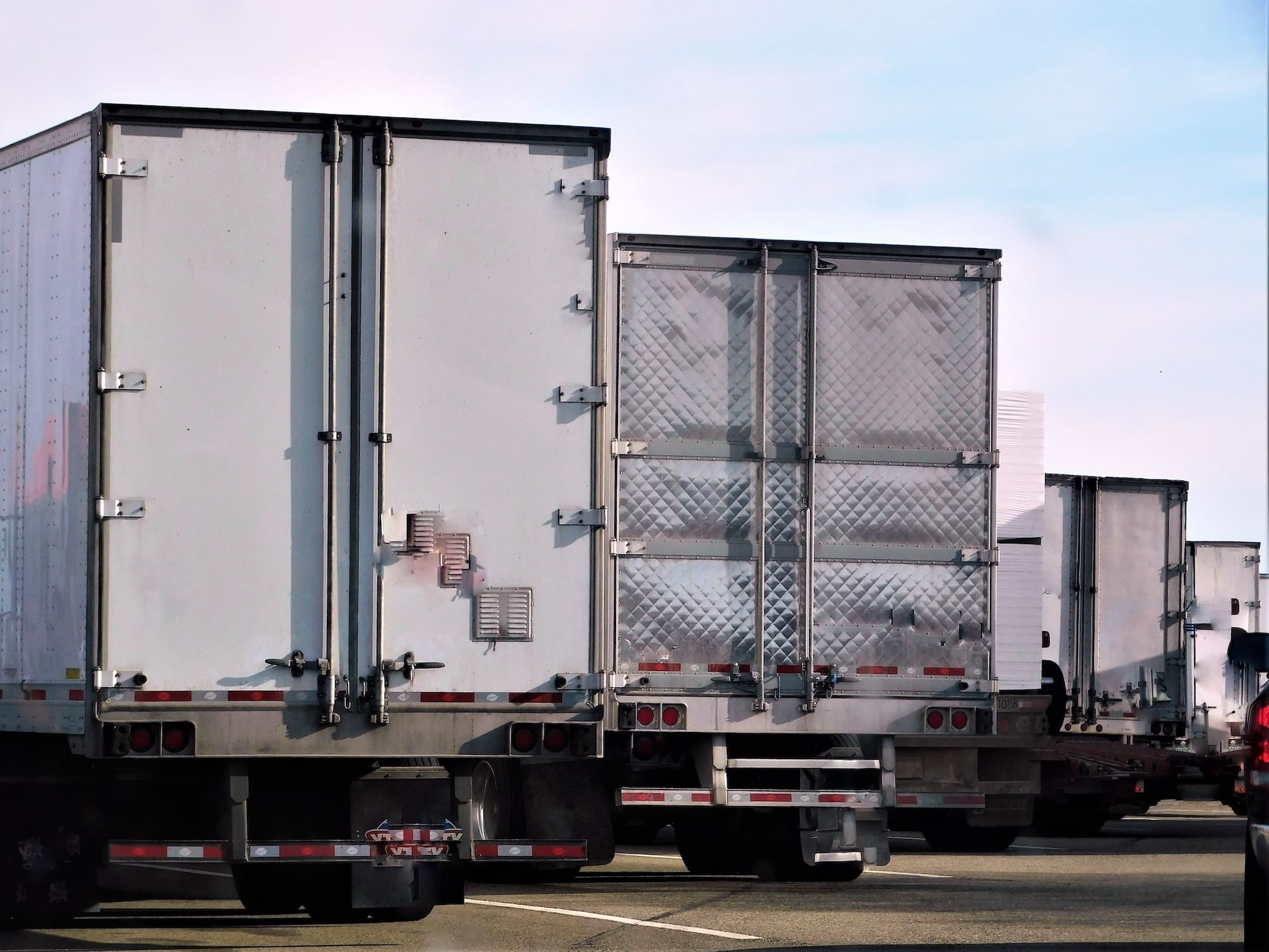 Large trucks and commercial vehicles parked in a parking lot